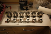 <p>6 ITB's from the GSXR spaced out next to the machined intake manifold.</p>